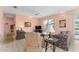 Cozy living room featuring tile floors, ceiling fan, and comfortable floral patterned furniture at 12687 Se 90Th Ter, Summerfield, FL 34491