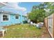 Private backyard featuring a lush lawn, a patio with seating, and well-maintained fencing at 1301 North Ave, Tavares, FL 32778