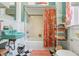 Unique bathroom with a turquoise sink, patterned shower curtain, and stylish shelving at 1301 North Ave, Tavares, FL 32778