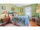 Relaxing bedroom featuring a blue and floral bedspread, wooden accents, and cozy decor at 1301 North Ave, Tavares, FL 32778