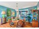 Charming dining room showcasing hardwood floors, bright colors, and seamless transition to the kitchen at 1301 North Ave, Tavares, FL 32778