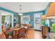 Cozy dining room with hardwood floors, a round table, and mid-century modern decor at 1301 North Ave, Tavares, FL 32778