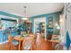 Vibrant dining area featuring hardwood floors and a seamless transition to the kitchen at 1301 North Ave, Tavares, FL 32778