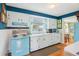 Well-lit kitchen featuring a vintage stove, white cabinets, and a view into the dining area at 1301 North Ave, Tavares, FL 32778
