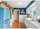 Bright kitchen showcasing a retro refrigerator, ample counter space, and wooden shelves at 1301 North Ave, Tavares, FL 32778