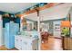 Inviting kitchen with a retro refrigerator, bar seating, and an open layout to the dining area at 1301 North Ave, Tavares, FL 32778
