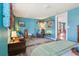 Cozy living room with blue walls, eclectic decor, comfortable seating, and natural light from the window at 1301 North Ave, Tavares, FL 32778