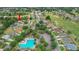 Aerial view of the property in a community with golf course, pool, and mature trees at 13050 Se 89Th Cir, Summerfield, FL 34491