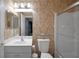 Cozy bathroom featuring a toilet, glass shelf, and shower with framed sliding doors at 13050 Se 89Th Cir, Summerfield, FL 34491
