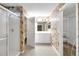 Bathroom showcasing floral wallpaper, a vanity, shower with glass doors, and a wire rack shelving unit at 13050 Se 89Th Cir, Summerfield, FL 34491