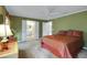 Bedroom with an attached bathroom showcasing bright neutral paint and a lighted ceiling fan at 13050 Se 89Th Cir, Summerfield, FL 34491