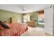 Cozy bedroom featuring neutral carpet, a ceiling fan, dresser, and windows with decorative curtains at 13050 Se 89Th Cir, Summerfield, FL 34491