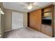Bedroom featuring carpet, a Murphy bed, and built-in storage at 13050 Se 89Th Cir, Summerfield, FL 34491
