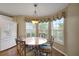Bright breakfast nook features a marble table, decorative light fixture, and plantation shutters at 13050 Se 89Th Cir, Summerfield, FL 34491
