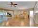 Spacious dining area featuring hardwood floors, a ceiling fan, with views of an adjoining living space at 13050 Se 89Th Cir, Summerfield, FL 34491