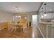 Open-concept dining room featuring a wooden table, chandelier, and wood floors at 13050 Se 89Th Cir, Summerfield, FL 34491