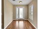 Inviting foyer with wood-look floors, a decorative glass front door, and a sidelight window at 13050 Se 89Th Cir, Summerfield, FL 34491