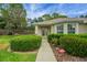 Charming single-story home with well-maintained landscaping, complemented by an inviting walkway at 13050 Se 89Th Cir, Summerfield, FL 34491