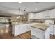Bright kitchen with white cabinets, granite countertops, and breakfast bar at 13050 Se 89Th Cir, Summerfield, FL 34491