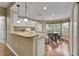 Bright eat-in kitchen featuring white cabinetry, granite countertops, breakfast nook with large windows at 13050 Se 89Th Cir, Summerfield, FL 34491