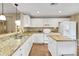 Bright kitchen with white cabinets, granite countertops, island and stainless steel appliances at 13050 Se 89Th Cir, Summerfield, FL 34491