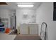 Dedicated laundry area with washer, dryer, and utility sink inside the garage at 13050 Se 89Th Cir, Summerfield, FL 34491
