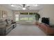Bright, open-concept sunroom featuring a ceiling fan and an outside view of the backyard at 13050 Se 89Th Cir, Summerfield, FL 34491
