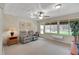 Bright, open-concept sunroom featuring a ceiling fan and an outside view of the backyard at 13050 Se 89Th Cir, Summerfield, FL 34491