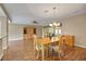 Open-concept living room featuring a chandelier, wood floors, and ample space at 13050 Se 89Th Cir, Summerfield, FL 34491