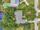 Birds-eye view of home with mature tree coverage, waterway access, and neighborhood details at 1341 W Lakeshore Dr, Clermont, FL 34711