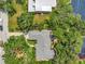 Aerial view of a charming home with lush trees and yard, situated on a waterfront property at 1341 W Lakeshore Dr, Clermont, FL 34711