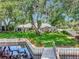 Lush backyard leading to a private dock and waterfront access, enhanced by mature trees at 1341 W Lakeshore Dr, Clermont, FL 34711