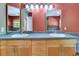 Bathroom featuring double sinks with wood cabinets, ample counter space, and updated fixtures at 1341 W Lakeshore Dr, Clermont, FL 34711