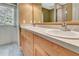Bathroom featuring double sinks, wood cabinets, and tile floors at 1341 W Lakeshore Dr, Clermont, FL 34711