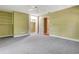 Bedroom with neutral carpet, green walls, built in shelving and walk-in closet at 1341 W Lakeshore Dr, Clermont, FL 34711