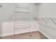 Spacious walk-in closet featuring wire shelving and neutral colored carpet at 1341 W Lakeshore Dr, Clermont, FL 34711