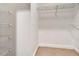 A walk in closet with wire shelving and neutral carpet at 1341 W Lakeshore Dr, Clermont, FL 34711