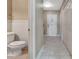 Entryway features access to a half bathroom with wainscoting, closet storage, and tile floors at 1341 W Lakeshore Dr, Clermont, FL 34711