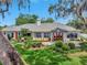 Well-maintained home with a landscaped front yard, a symmetrical facade, and an inviting front entrance at 1341 W Lakeshore Dr, Clermont, FL 34711