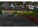 Stunning single-story home with a large garage, mature landscaping, and a charming covered entryway at 1341 W Lakeshore Dr, Clermont, FL 34711