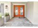 Inviting front entrance with double doors, stone floors, and modern planter boxes for added curb appeal at 1341 W Lakeshore Dr, Clermont, FL 34711