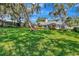 Lush front yard and sprawling lawn with mature trees shading this beautiful home at 1341 W Lakeshore Dr, Clermont, FL 34711