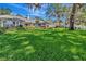 Spacious front yard with healthy lawn and mature trees shading the home at 1341 W Lakeshore Dr, Clermont, FL 34711