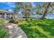 Well-manicured front yard showcasing lush lawn and mature trees near the waterfront home at 1341 W Lakeshore Dr, Clermont, FL 34711