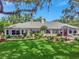 Well-manicured lawn and landscaping complement the home's architecture, creating a welcoming view at 1341 W Lakeshore Dr, Clermont, FL 34711