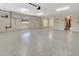 Spacious garage with clean flooring, overhead lighting, and organizational hooks at 1341 W Lakeshore Dr, Clermont, FL 34711
