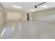 Large two-car garage featuring epoxy flooring, bright lighting, and utility connections at 1341 W Lakeshore Dr, Clermont, FL 34711