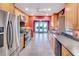 Modern kitchen featuring stainless steel appliances, tile flooring and backyard views at 1341 W Lakeshore Dr, Clermont, FL 34711