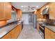 Spacious kitchen features light wood cabinets, stainless steel appliances, and a tile backsplash at 1341 W Lakeshore Dr, Clermont, FL 34711