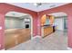 Open floorplan from living room featuring fireplace through kitchen with wood cabinets at 1341 W Lakeshore Dr, Clermont, FL 34711
